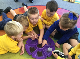 A group of children playing with different materials
