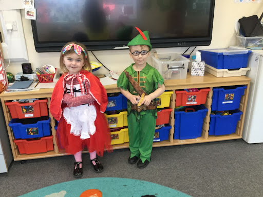 Two Nursery children are seen in dress-up costumes.